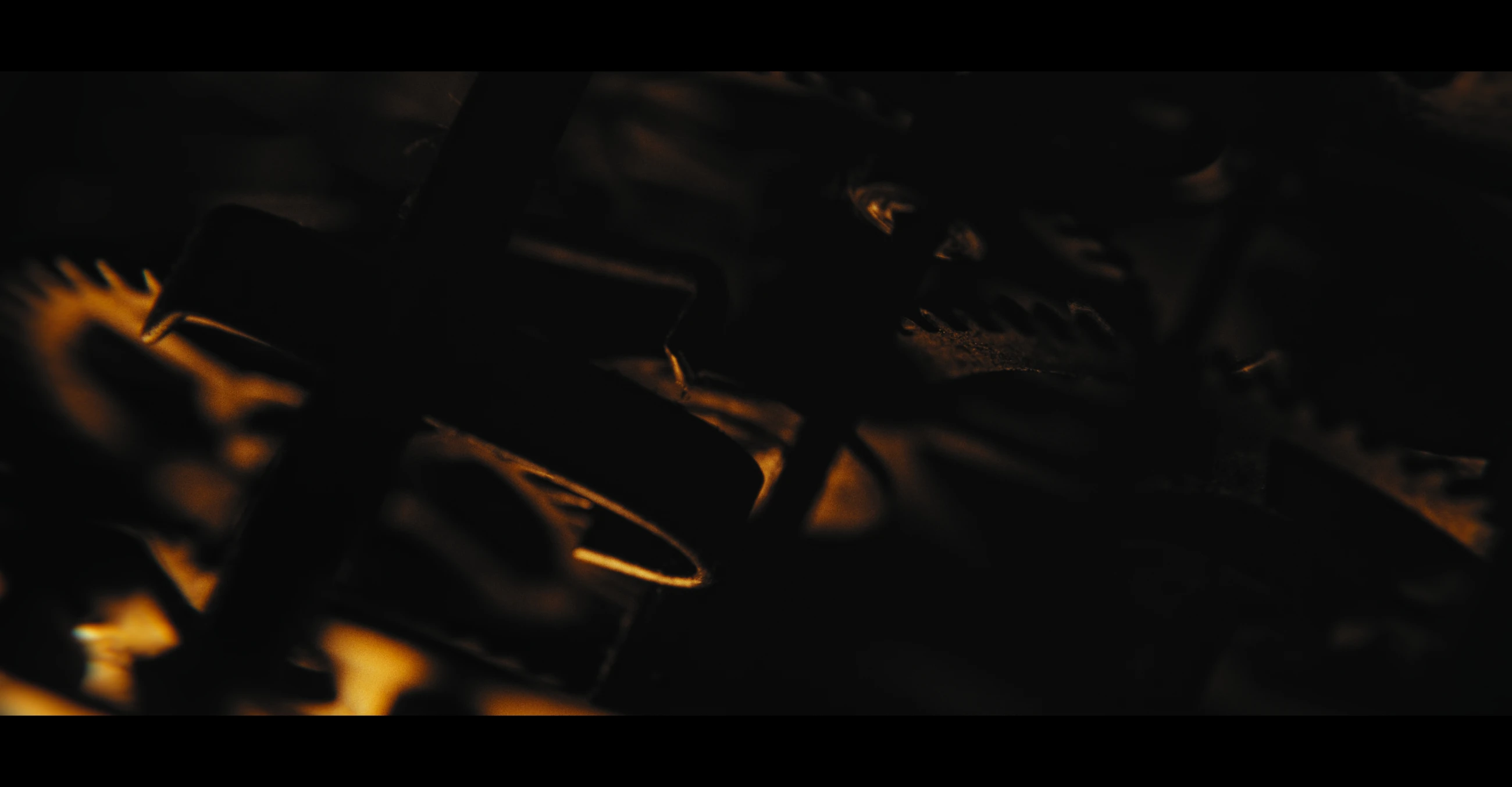 Hands reach across a dark table lit by warm reflections in The Maze.