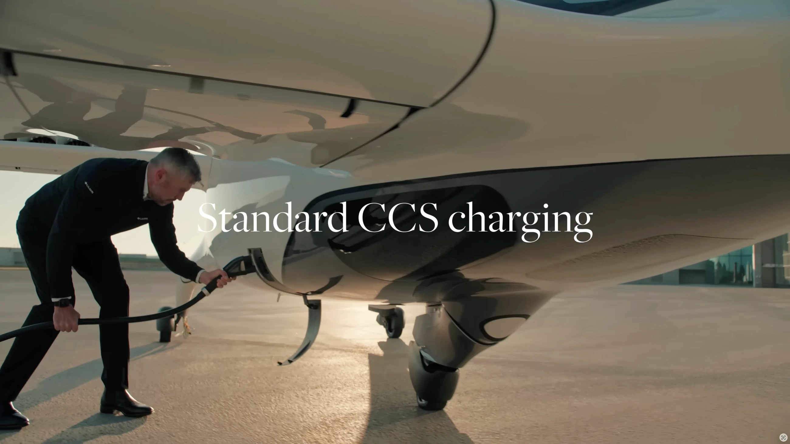 A technician connects a charging cable to a Lilium electric aircraft.